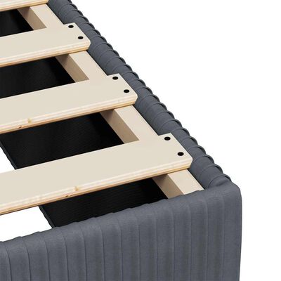 Close-up of the wooden slats and corner of the bed frame showing construction details.