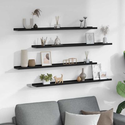 Black long shelf with decorative frames and objects arranged along its length