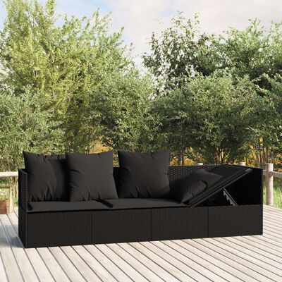 A dark wicker outdoor sectional with a hinged lid storage/bench and five black cushions on a wooden deck.