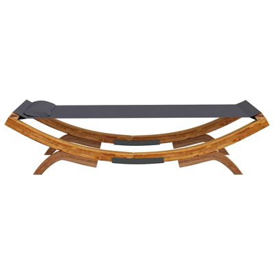 Front/side view of curved wooden lounge bed with dark gray surface and matching cushions.