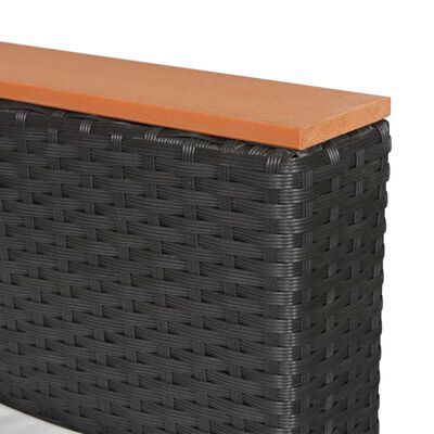 Close-up of the corner of the wicker outdoor furniture showing woven pattern and wooden top.