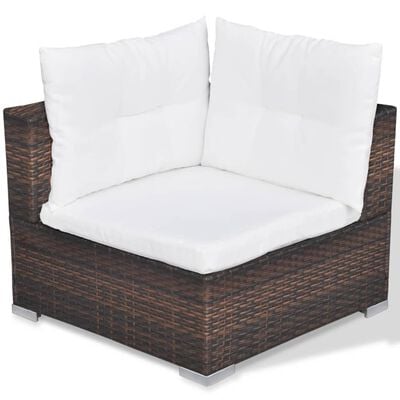 Brown wicker sofa with white cushions and two back cushions