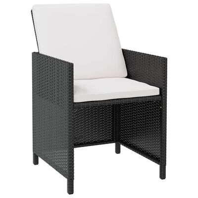 Close-up of a dark wicker armchair with white cushion.