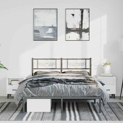 A bedroom scene with a metal bed frame and two white nightstands, two framed artworks above, and a checkered bedspread.