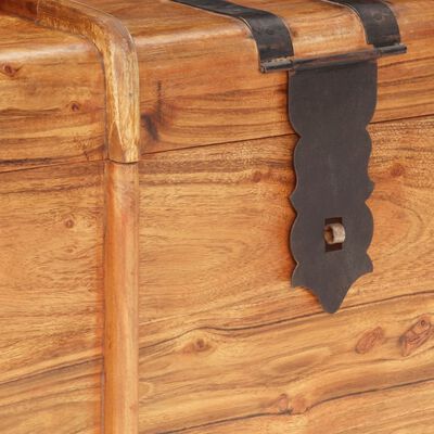 Close-up of ornate black metal latch on wooden chest