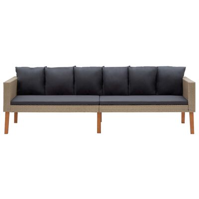 Wicker sofa with dark gray cushions and exposed wooden legs