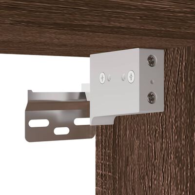 close-up of mounting bracket attached to wood panel for wall cabinet assembly.