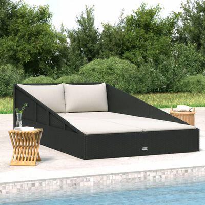 Sectional outdoor daybed with beige cushions and a small side table by a pool