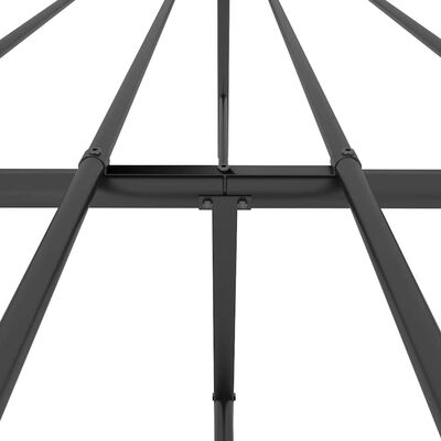 Close-up of metal grid frame joints and tubes showing construction details of bed frame.