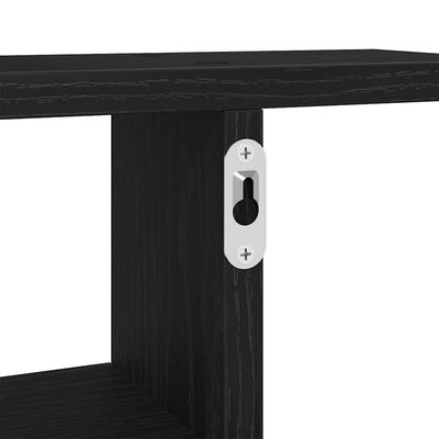 Close-up of a metal wall mounting plate attached to a wooden shelf