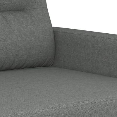 Close-up of sofa arm and seat cushion seam in grey fabric.