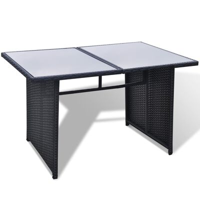 Rectangular dining table with glass top, dark wicker base.