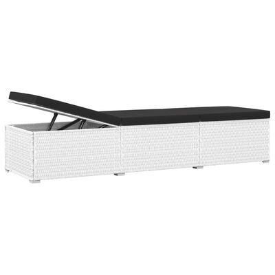 White wicker sectional with hinged top open to reveal storage inside, black cushions.