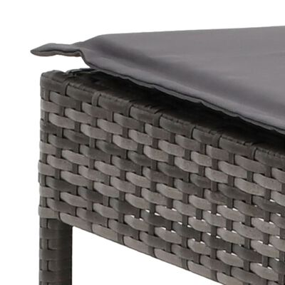 close-up of dark gray fabric cushion on wicker frame showing weaving and edge seam.