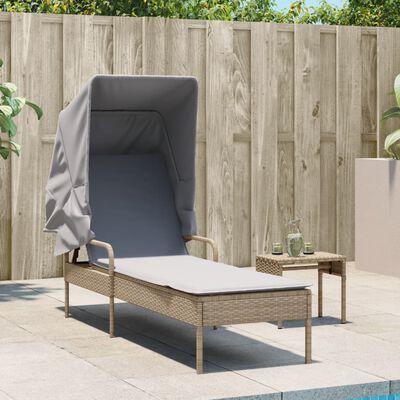 Lounge chaise showing front side with canopy and cushioned top, set against wooden fence.