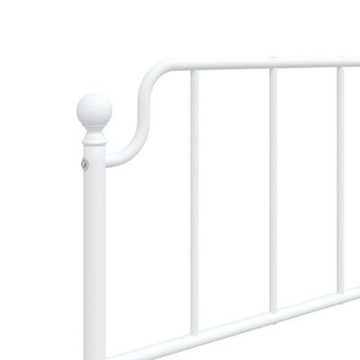 Close-up of a white bed frame post with decorative knob and curved top rail