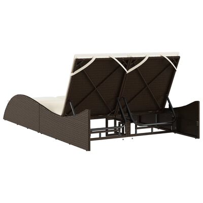underside view of a brown wicker outdoor daybed showing metal frame and support legs