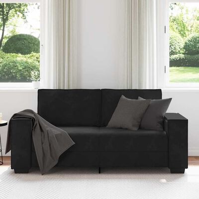 Black fabric sofa with two back cushions and one gray throw pillow in a bright room
