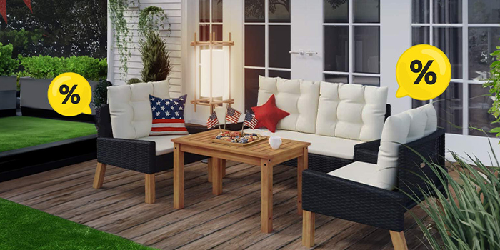 Black wicker furniture set with white cushions, wooden table, decorations, American flags, and yellow discount bubbles on a styled patio. Click to see the products in the offer.